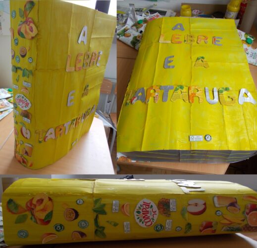 A capa do nosso livro amarelo é feita com embalagens tetrapak da Compal, coladas e pintadas, enfeitada com letras recortadas e imagens das embalagens Compal.